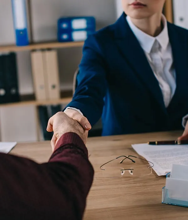 An attorney greeting a client at a consultation